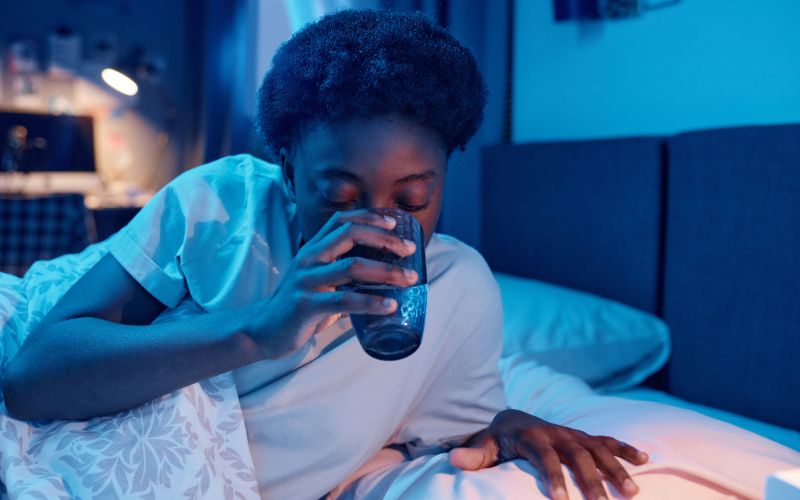 The Importance of Sleep for Menopause Weight Loss 4 A woman sipping herbal tea before bed, illustrating how pre-sleep habits can improve sleep quality