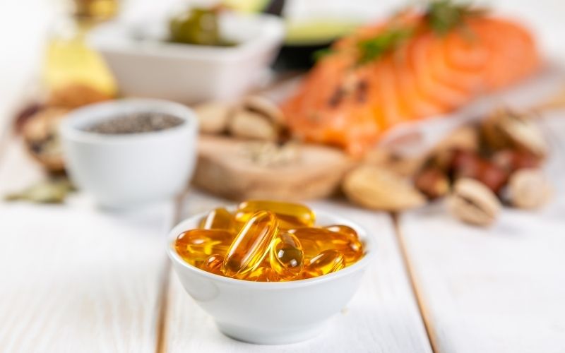 Best Menopause Supplements for Weight-Loss: Boost Your Weight-Loss Journey During Menopause 3 Fish oil supplements displayed alongside a healthy meal : Best menopause supplements for weight-loss